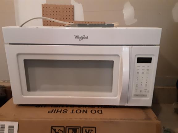 Microwave Whirlpool has 2 speed fan/light/clock. mounts above stove. for sale in Mchenry IL